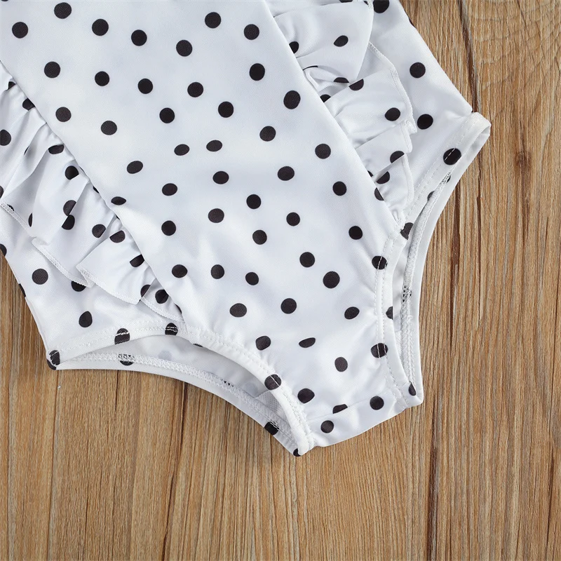 Maillot de bain bébé blanc à pois noirs une pièce volanté