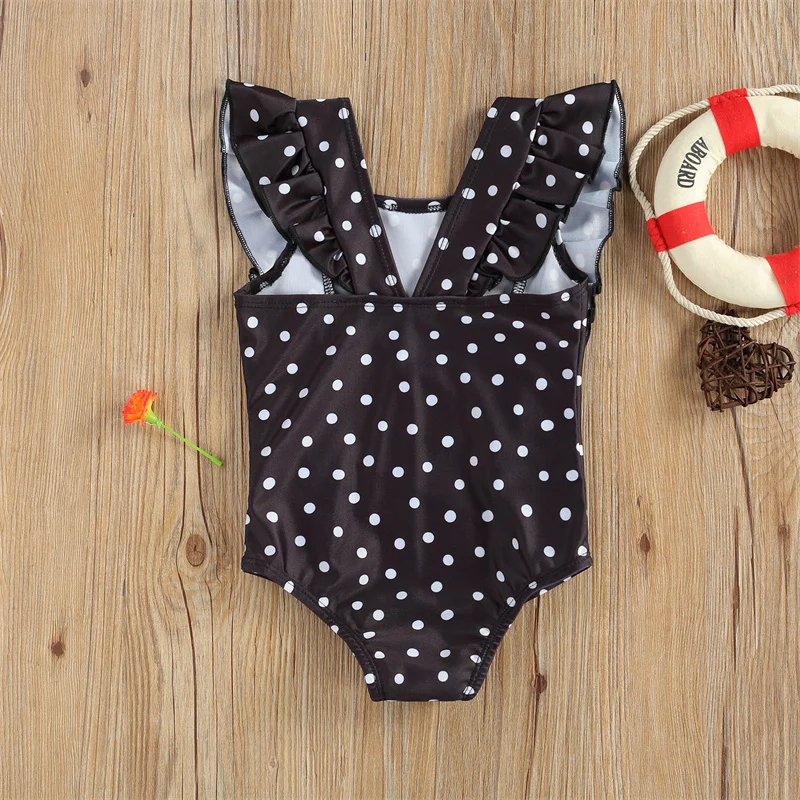 Maillot de bain bébé noir à pois blancs une pièce volanté